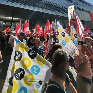 Gewerkschafterinnen und Gewerkschafter mit Fahnen an einer Demonstration