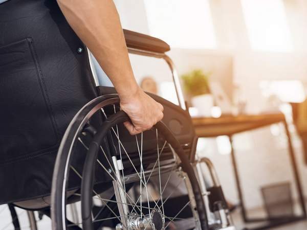 Person im Rollstuhl am Arbeitsplatz